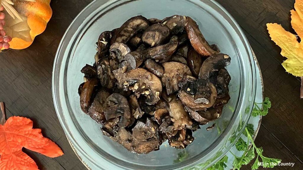 Bowl of herb roasted mushrooms made with garlic and olive oil, a healing recipe for MS and EBV Thanksgiving meal.