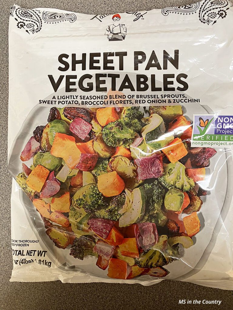 Bag of frozen sheet pan vegetables with Brussels sprouts, sweet potato, broccoli, red onion, and zucchini.