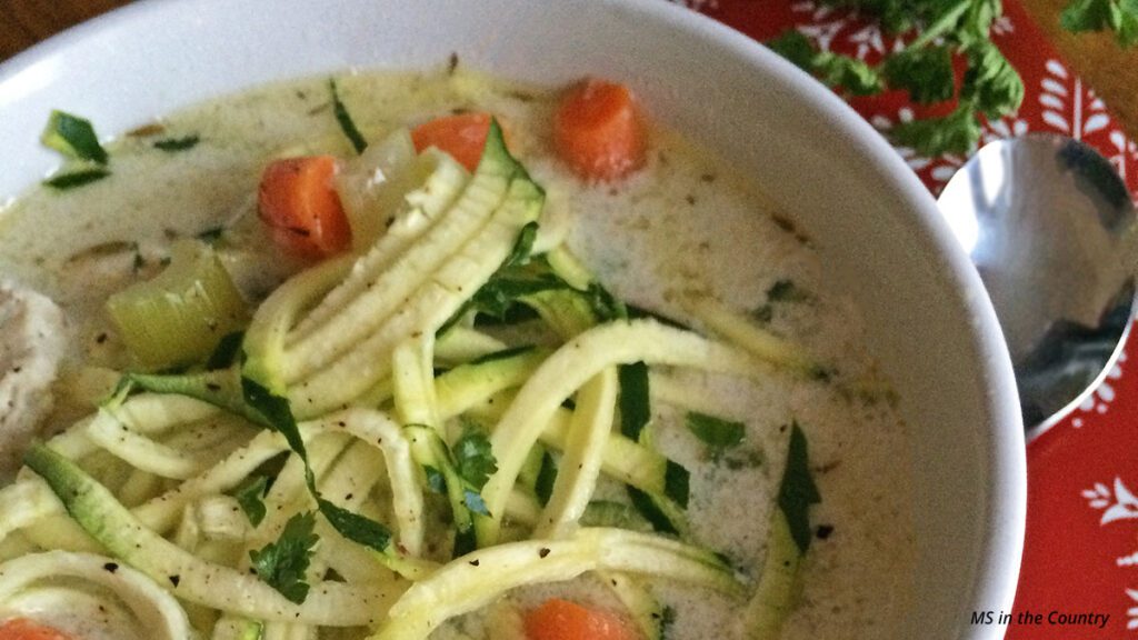 Bowl of easy chicken zoodle soup with zucchini noodles and carrots