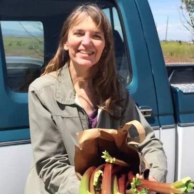 Cathy, author of MS in the Country, holding fresh rhubarb from a local farmer.